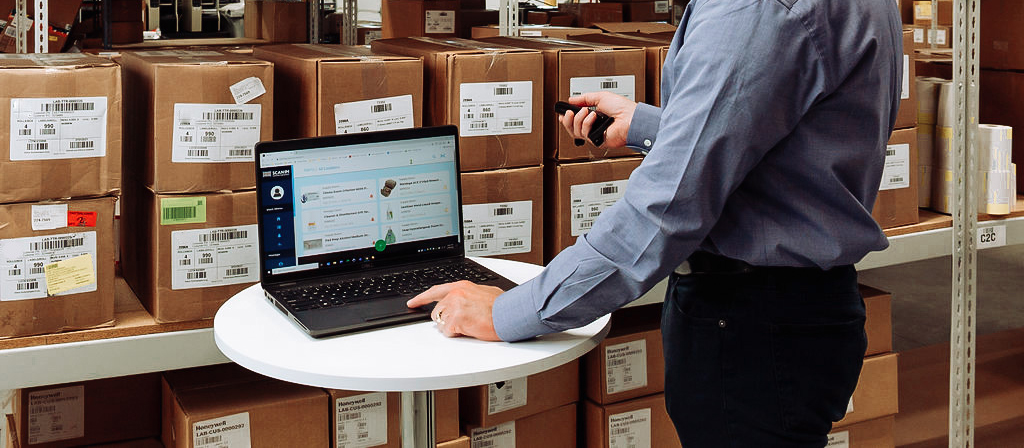 Employee using inventory management with barcode scanning